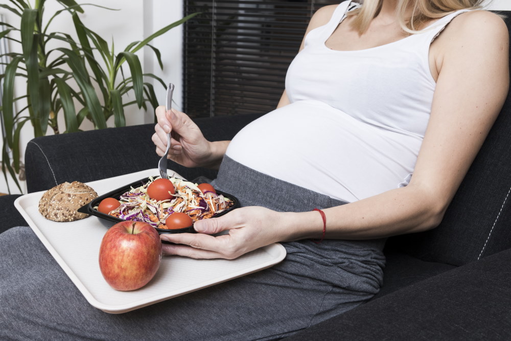 Pregnant Woman Eats Salad And Fruit