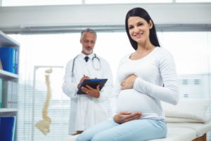 Pregnant woman with her doctor